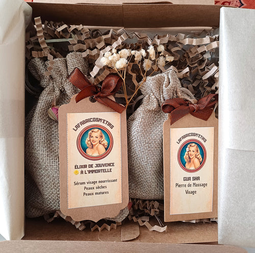 Coffret L'Élixir Enchanté ouvert LaFabricosm’etiks avec sérum Élixir de Jouvence à l'immortelle et Gua Sha en pierre verte.